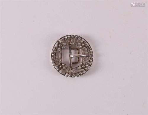 A silver belt buckle decorated with Zeeland buttons, circa 1...