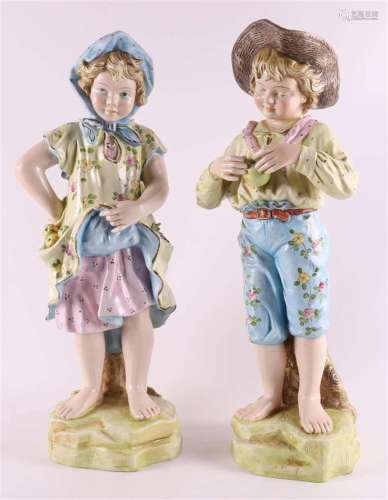 A porcelain girl and boy with apples, Germany, circa 1900.