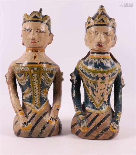 A pair of terracotta polychrome seated figures in Javanese s...