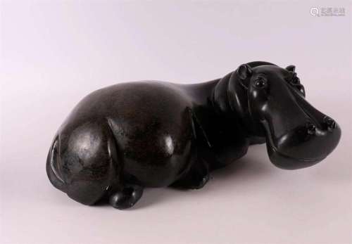 A black stone hippopotamus, 20th/21st century.