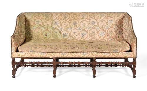 A WALNUT AND EMBROIDERY UPHOLSTERED SOFA, CIRCA 1710 AND LAT...
