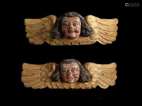 A PAIR OF CARVED, PAINTED AND GILDED WINGED ANGEL ORNAMENTS,...