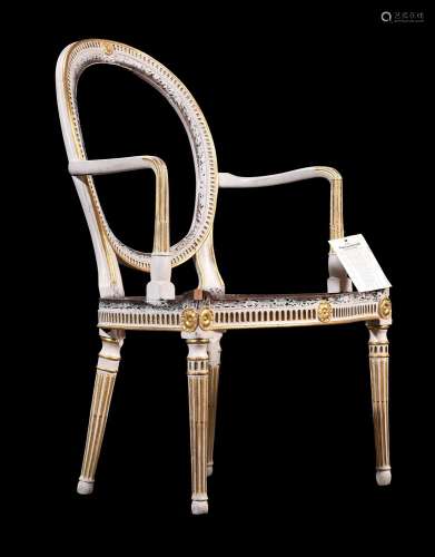 A GEORGE III CREAM PAINTED AND PARCEL GILT ELBOW CHAIR, IN T...