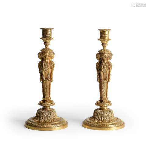 A PAIR OF FRENCH ORMOLU CANDLESTICKS, AFTER A MODEL BY JEAN-...