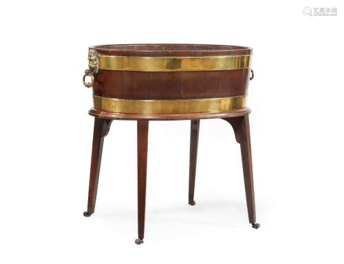 A GEORGE III MAHOGANY AND BRASS BOUND WINE COOLER, IN THE MA...