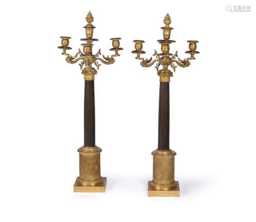 A PAIR OF FRENCH ORMOLU AND PATINATED BRONZE FIVE-LIGHT CAND...
