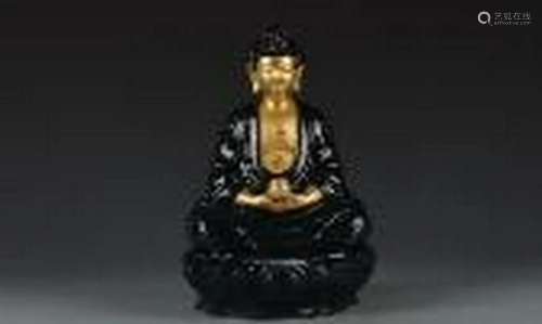 Gold buddha with black glazing clothes