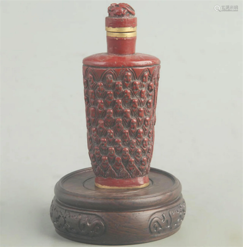 A FINE RED CARVED LACQUER BOY CARVING SNUFF BOTTLE
