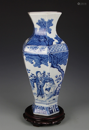 BLUE AND WHITE BOY PLAYING SIX SIDED VASE