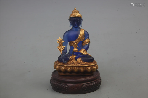 A FINELY GILT GLASS MADE BHAISAJYAGURU BUDDHA