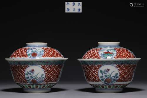 In the Qing Dynasty, a pair of cup-lid cups were carved with...
