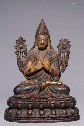 A sitting statue of Zongkhapa in purple sandalwood lacquer, ...