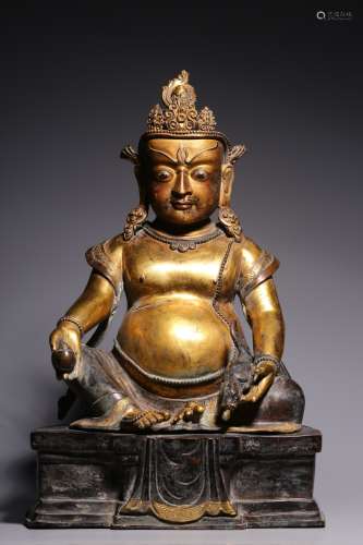 Qing Dynasty, bronze gilt yellow god of wealth sitting statu...