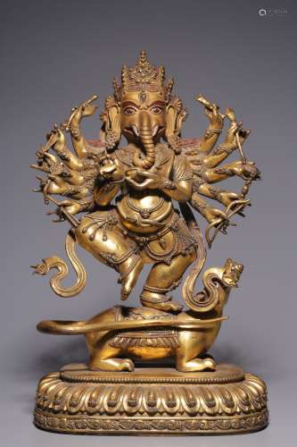A bronze gilt statue of the god of Wealth with twelve arms