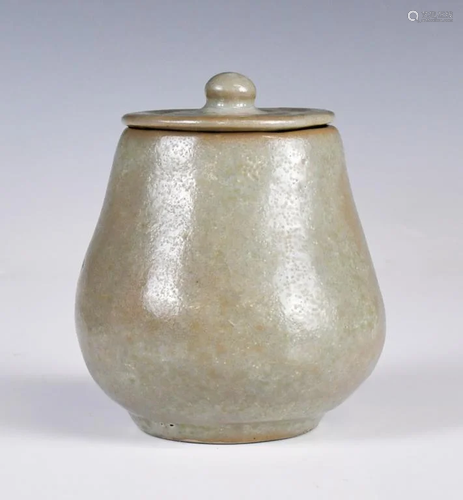 A Small Celadon-Glazed Jar With Cover