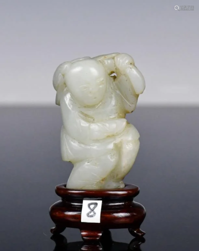 A White Jade Carved Boy with Stand Qing