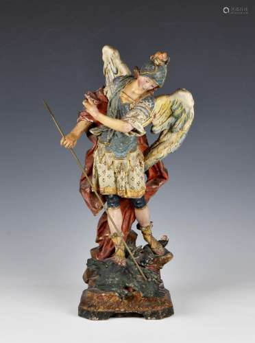 A 19th century painted and gilded terracotta figure of St Mi...