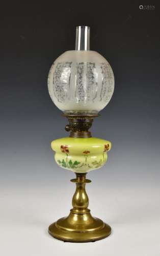 A 19th century oil lamp with a floral painted green glass re...