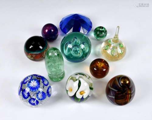 A collection of 20th century glass paperweights comprising a...