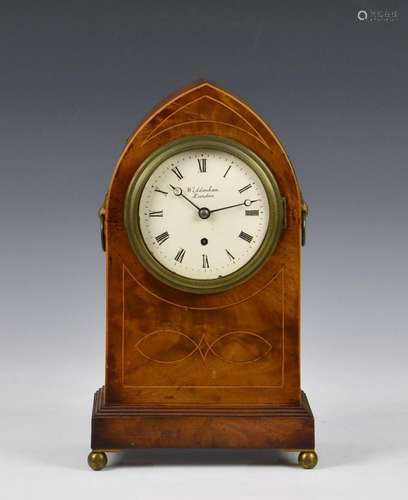 An early 19th century arched inlaid mahogany mantel clock by...