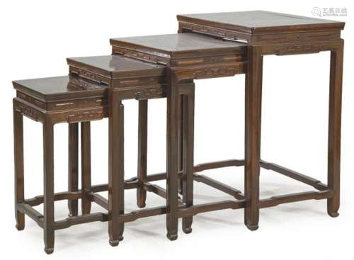 Set of four Chinese nesting tables with carved decoration an...