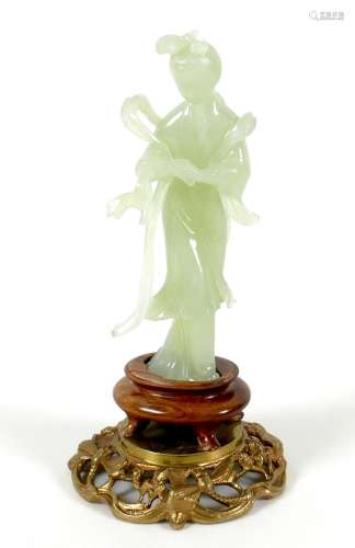 A Chinese carved jade figure, late 20th century, modelled as...