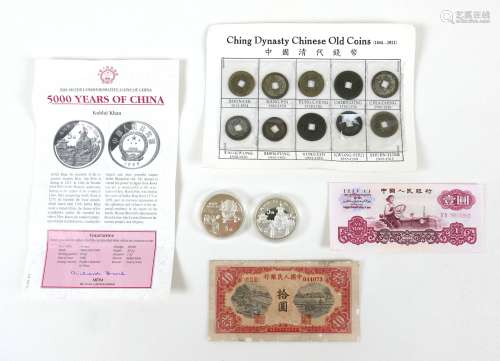 A small group of Chinese coins and banknotes, comprising two...