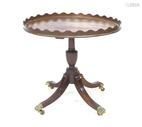 A mahogany side table, in Regency style, with oval surface, ...