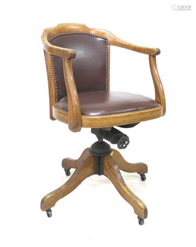 A vintage oak framed office swivel chair, circa 1920, with s...