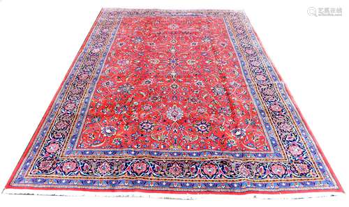 A Sarough rug, with floral design across central red ground ...