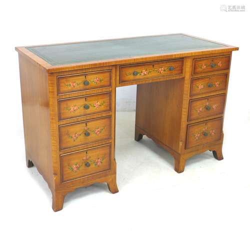 An Edwardian satinwood pedestal desk, the surface with a gil...