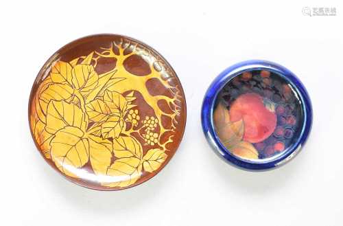 A Moorcroft dish and Cirencester Pottery slipware saucer
