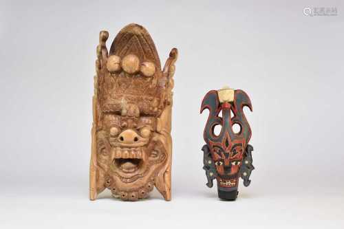 A Balinese wall mask and three Malaysian wood masks