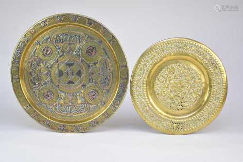 A Persian inlaid brass dish and an embossed brass dish