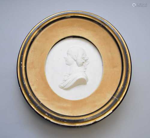 A carved white marble cameo portrait of a young woman