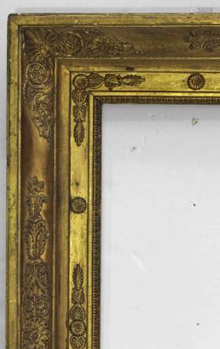 A FRENCH EMPIRE GILTWOOD PICTURE FRAME with raised stylised ...