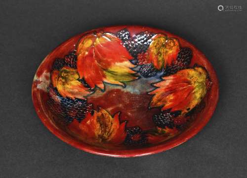 MOORCROFT FLAMBE PLATE - LEAF & BERRY a plate painted in...