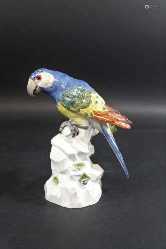 MEISSEN PARROT 20thc, brightly painted and perched on a rock...