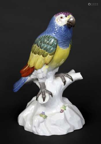 MEISSEN PARROT 20thc, brightly painted and perched on a tree...
