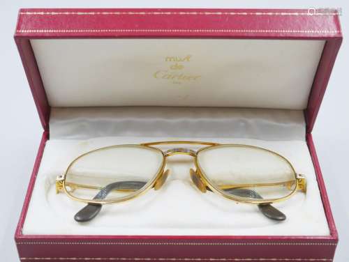 CARTIER. Paire de lunettes en plaqué or, modèle Vendôme.Sign...