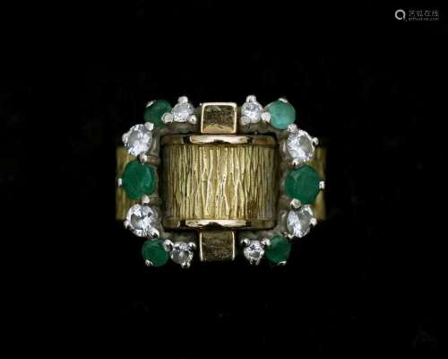 An 18 karat gold ring with diamonds and emeralds
