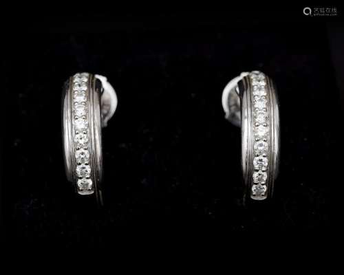 A pair of 18 karat white gold earrings by Piaget, with diamo...