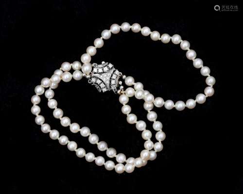 A pearl bracelet with a 14 karat white gold decorative clasp...