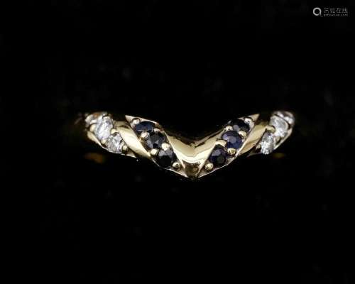 An 18 karat gold chevron ring, set with sapphires and diamon...