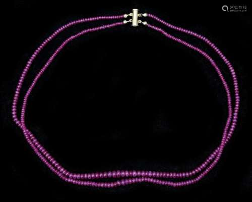 A double strung string of rubies on 18 karat gold magnetic l...