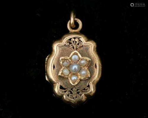 A 14 karat rose gold medallion, set with pearls