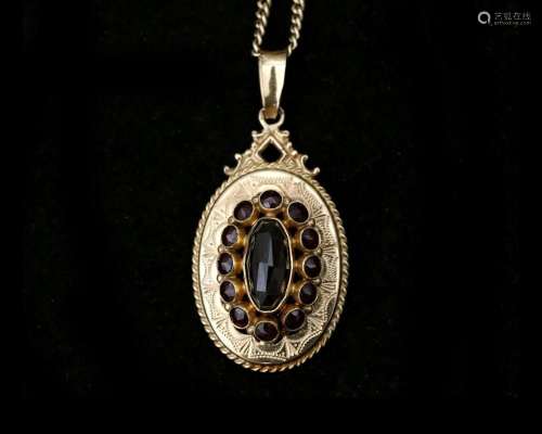 A 14 karat gold gourmet link necklace with garnet pendant