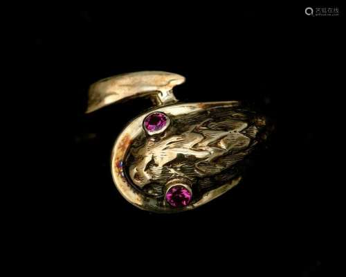 A 14 karat gold ring in the shape of a snake, set with ruby ...