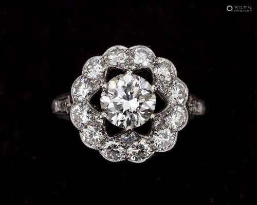 A 14 karat white gold with platinum rosette ring, set with d...
