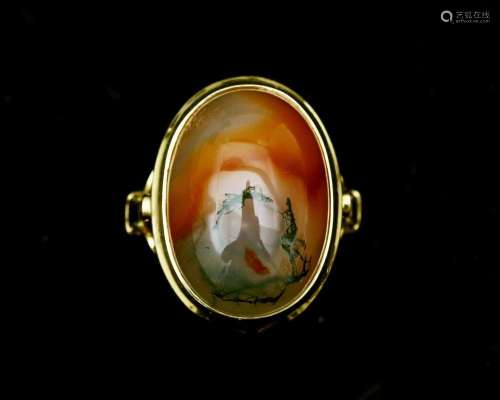 A 14 karat gold ring with cabochon cut moss agate